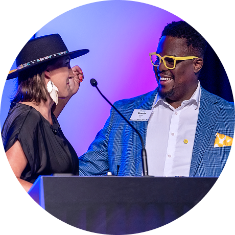 Speakers celebrating on stage at an event